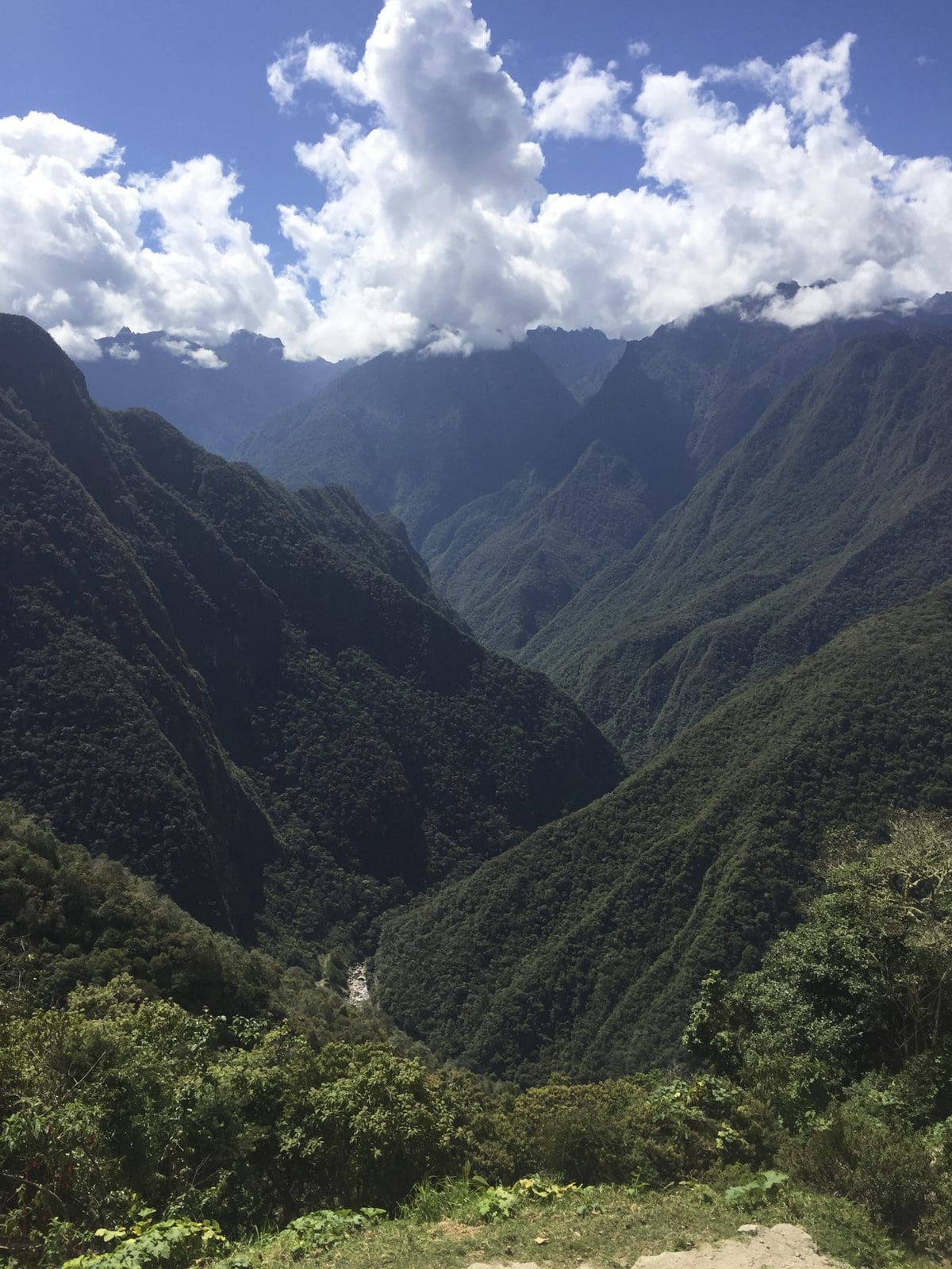 Steep green mountains and the valley below, seen from the Inca Trail
