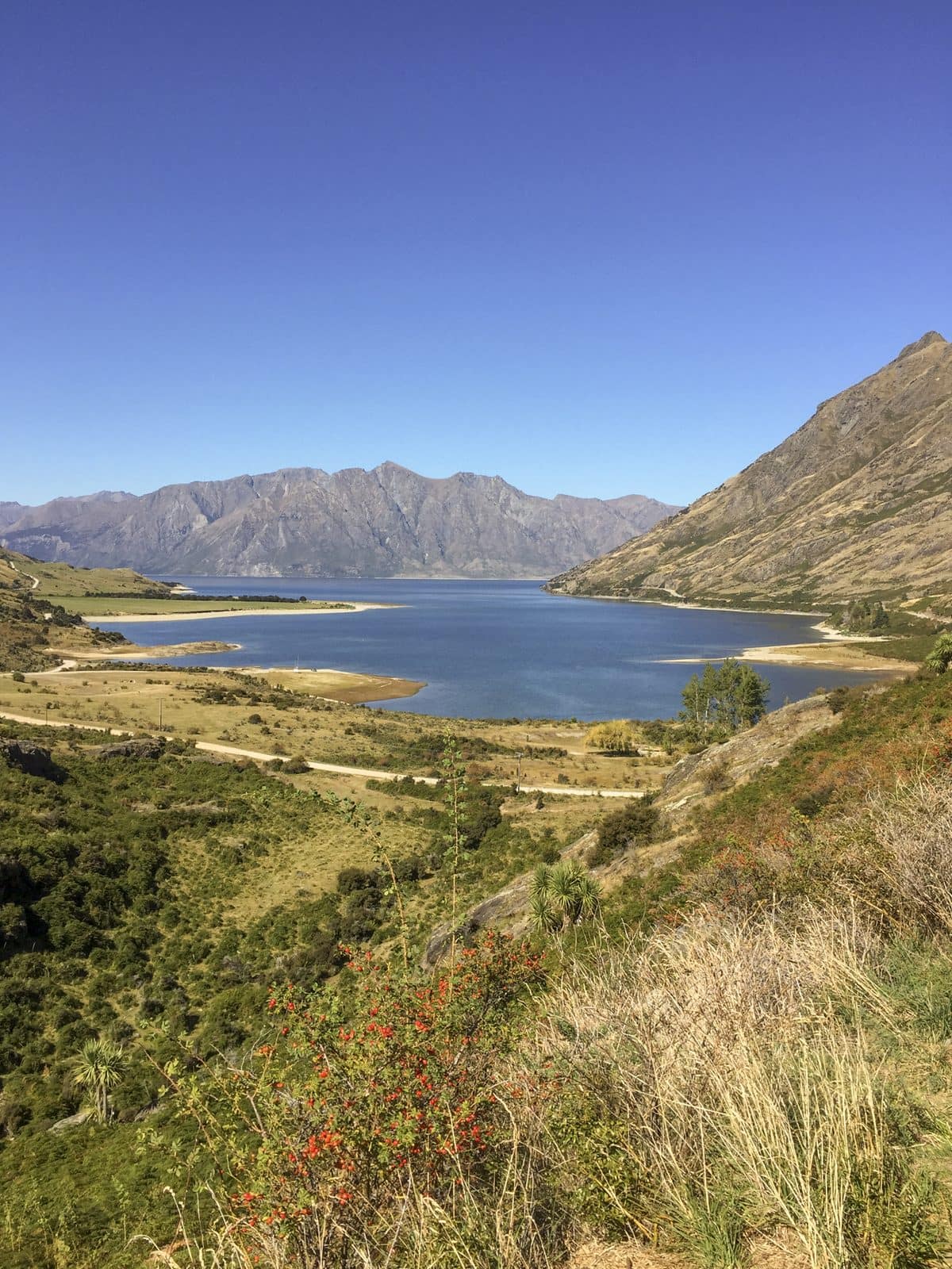 The deep blue of Lake Hawea between the hills