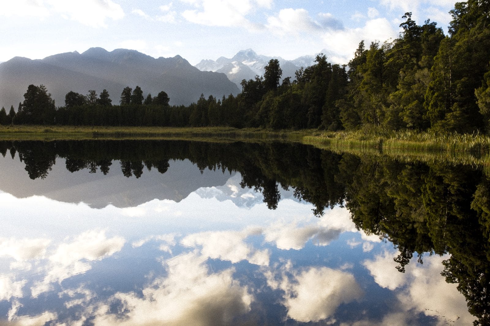 Mountains mirrored in the still water of Lake Matheson
