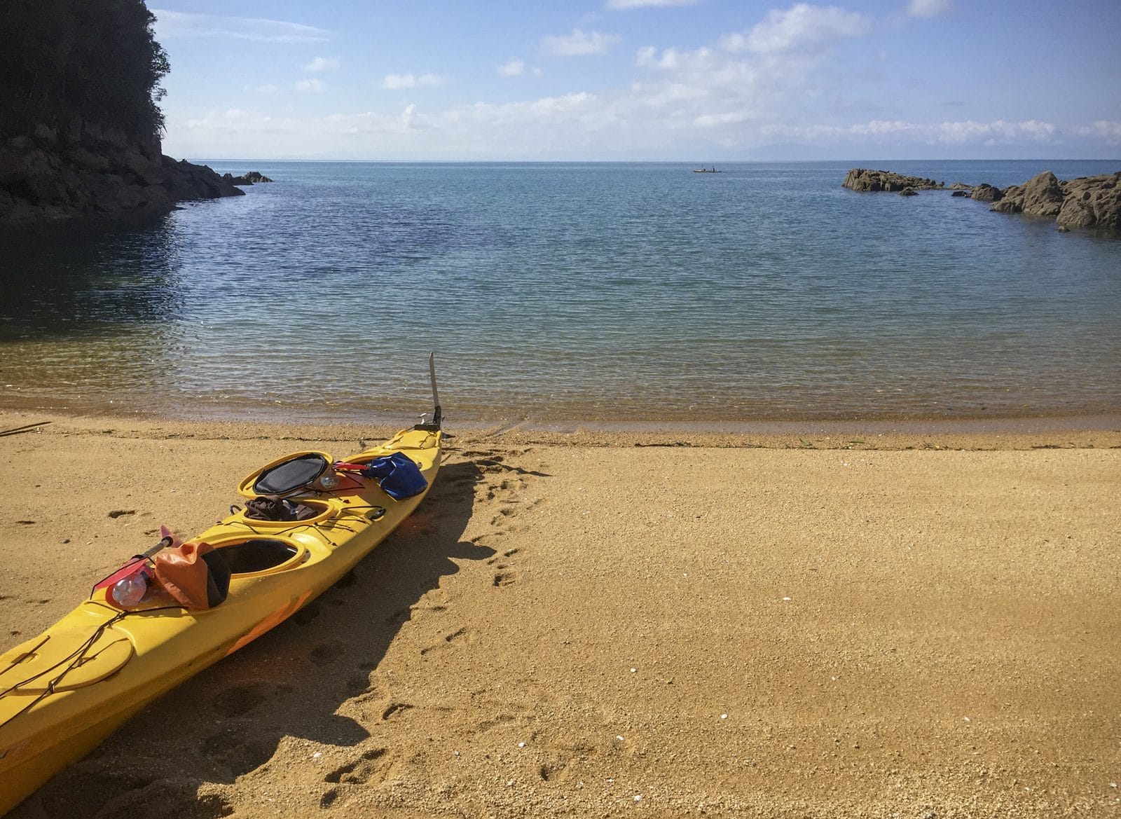 A sea kayak pulled up on the beach in Abel Tasman