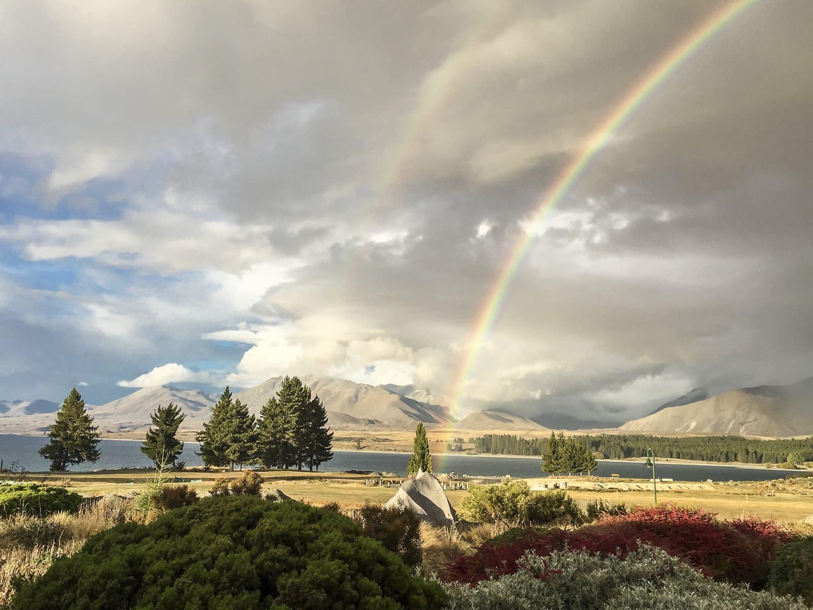 A rainbow arching over Lake Tekapo