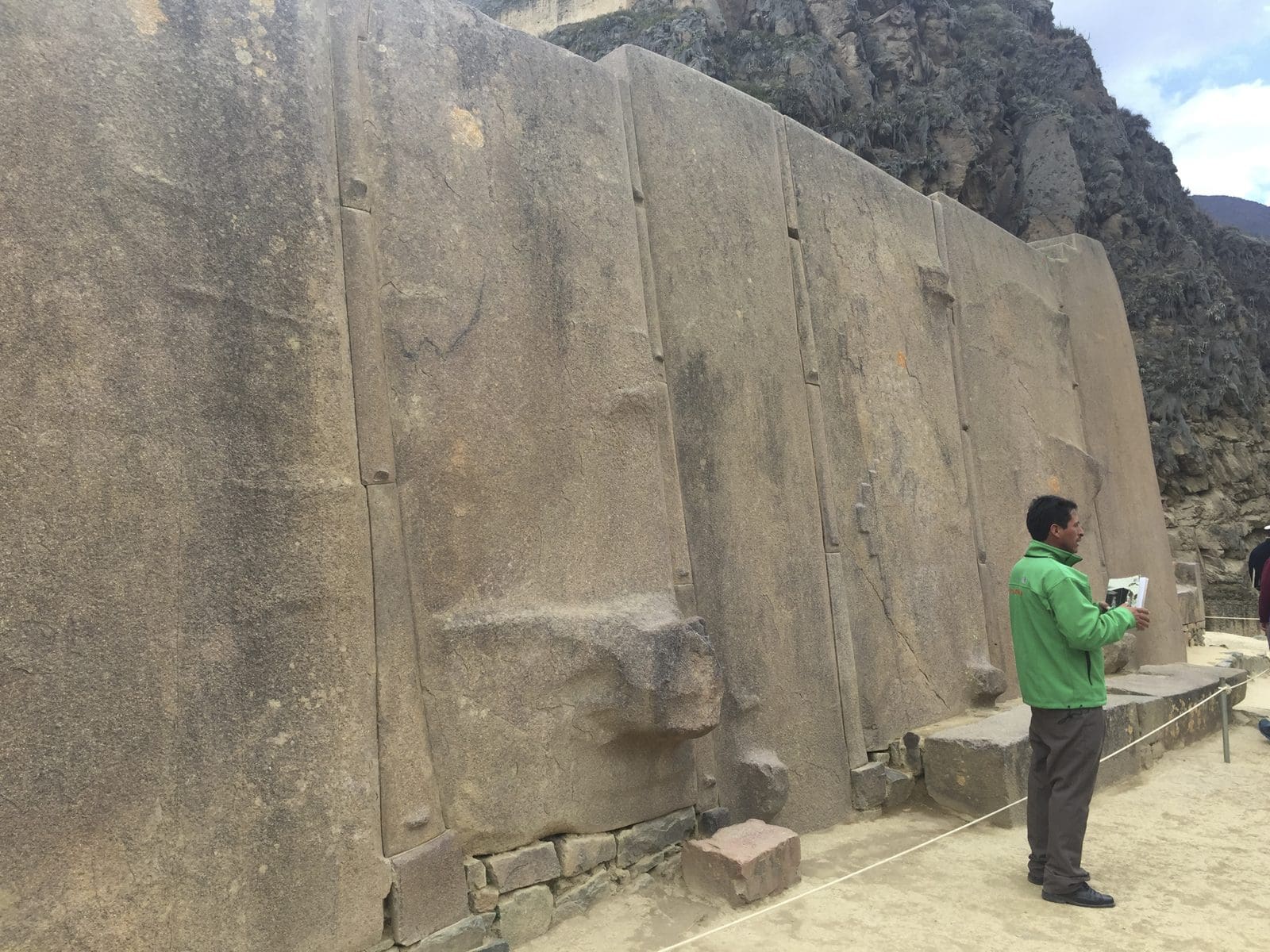 A man dwarfed by the giant fitted stones of the Saqsayhuaman walls above Cusco