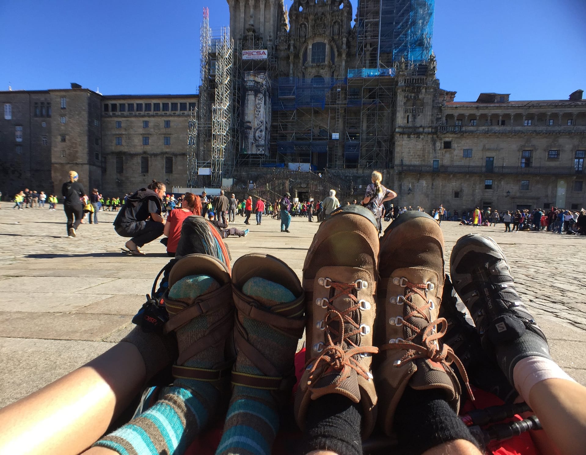 Walking boots off in the square outside Santiago de Compostela cathedral