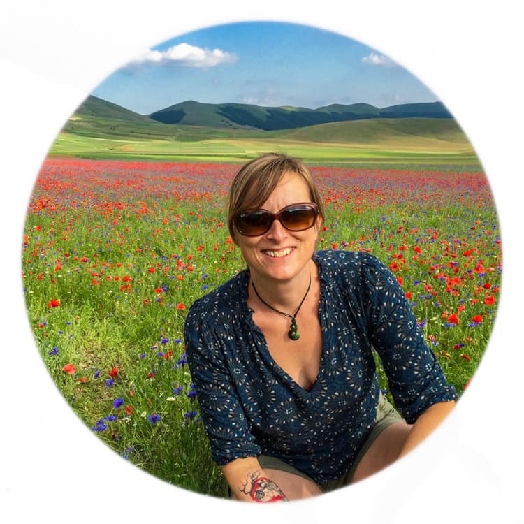 Julie in a field of poppies and wildflowers in Umbria, Italy