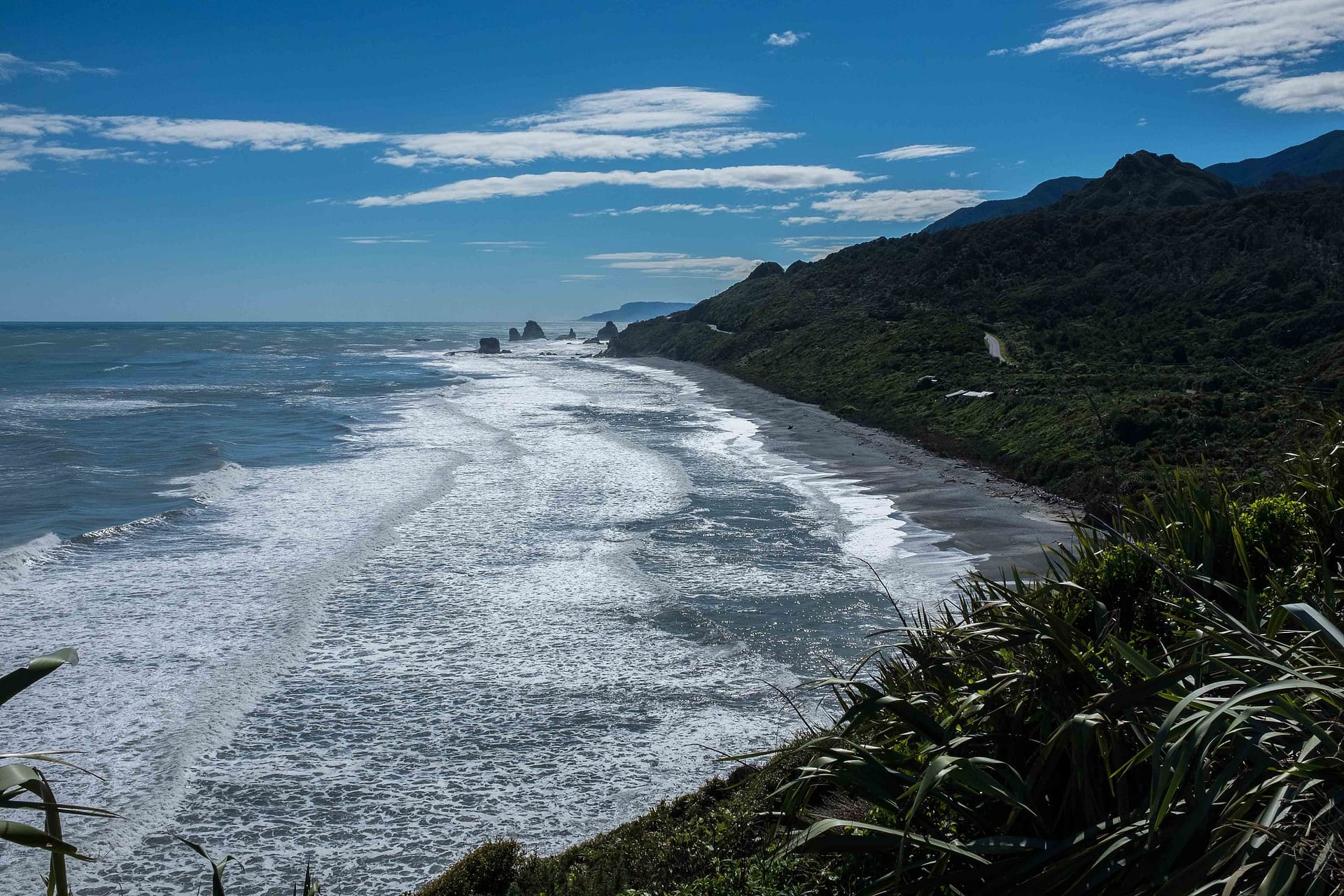 Surf breaking along the rugged West Coast of New Zealand