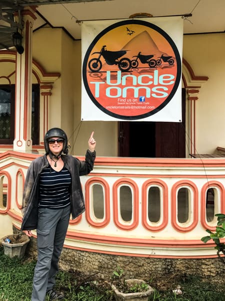 Julie on a hired motorbike outside Uncle Tom&rsquo;s, Laos