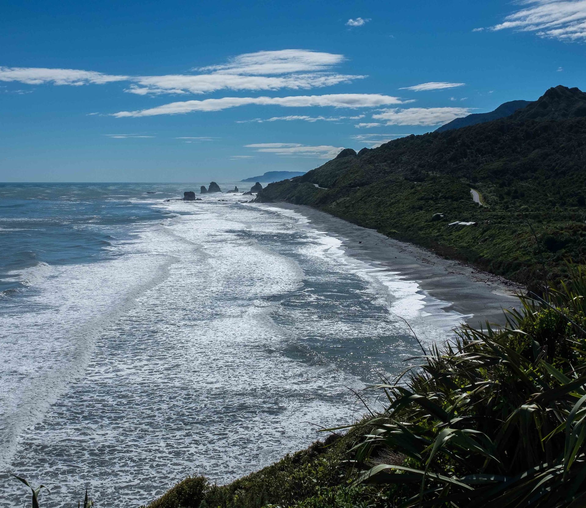 Surf breaking along the rugged West Coast of New Zealand